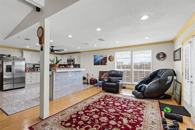 a kitchen with stainless steel appliances granite countertop a stove and a living room