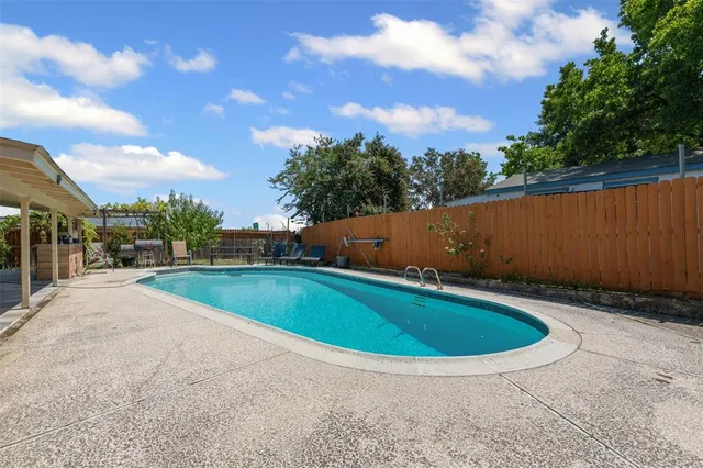 a bathroom with a sink a toilet a mirror and shower curtain