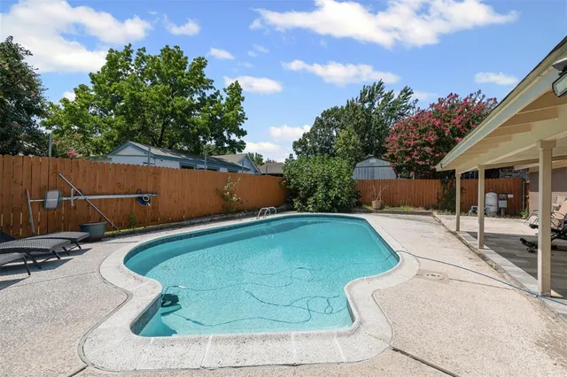a view of patio with swimming pool and furniture