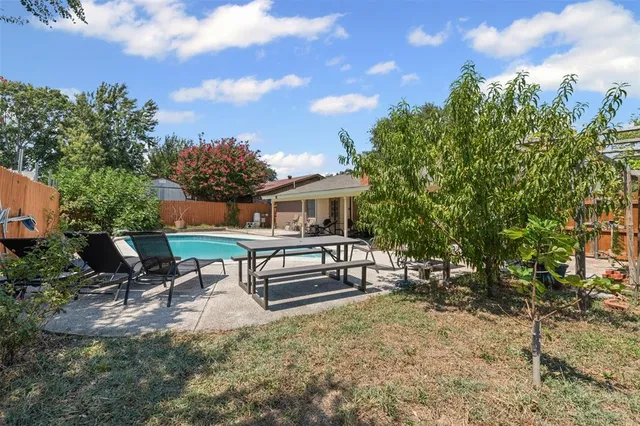 a view of a house with swimming pool and sitting area
