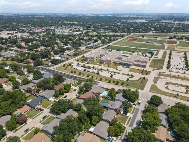 a view of a patio with table and chairs a barbeque grill with wooden fence