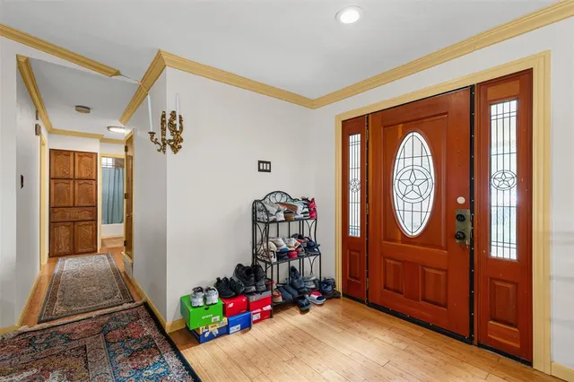 a view of an entryway with wooden floor