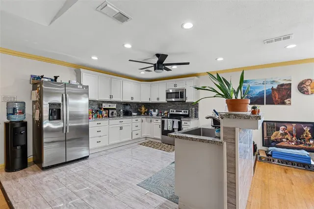 a kitchen with refrigerator and cabinets