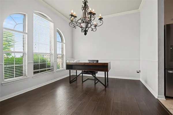 a spacious bedroom with a bed and a flat screen tv