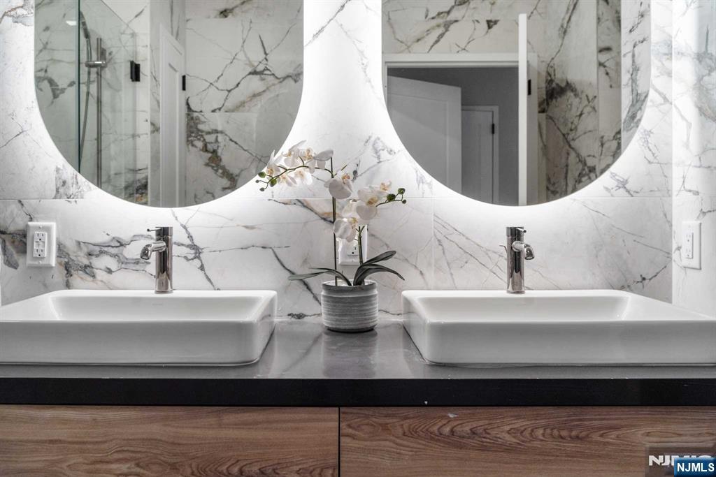 7101 River Road, Unit 304A North Bergen, NJ 07047 - Photo 12 of 24 a bathroom with a sink mirror and vanity