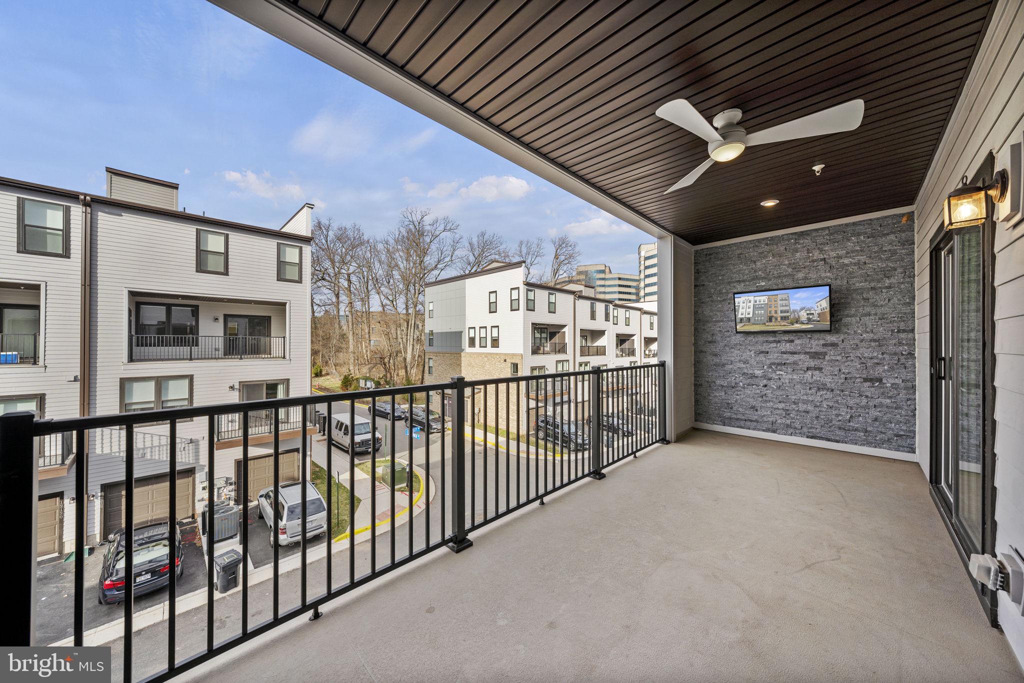 4118 Legato Road, Unit 60 Fairfax, VA 22033 - Photo 9 of 26 Outdoor balcony with ceiling fan & wall mounted tv