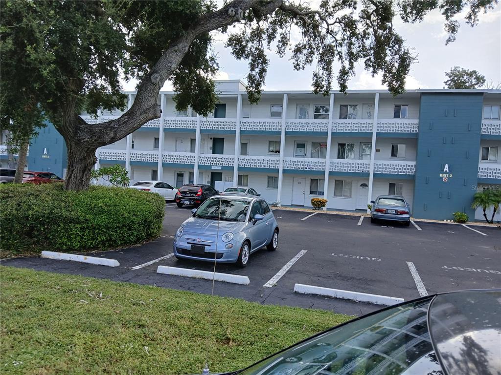 5929 17th Street West, Unit A22 Bradenton, FL 34207 - Photo 1 of 1 a front view of a house with a garden and trees
