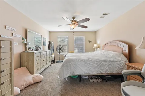 a bedroom with furniture and a chandelier