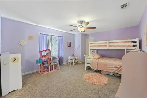 a bed room with furniture and a flat screen tv