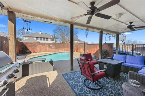 a living room with furniture a dining table and a large window