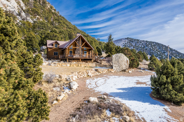 18906 North Canyon Road Whiterocks, UT 84085 - Photo 59 of 65 Rear view of property with a metal roof, a chimney, and a deck with mountain view