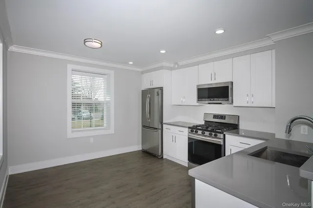 a kitchen with stainless steel appliances a stove sink microwave and refrigerator