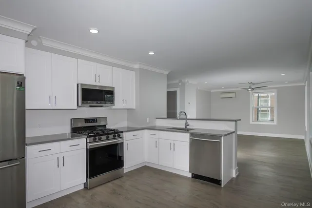 a kitchen with stainless steel appliances granite countertop a sink and a stove top oven