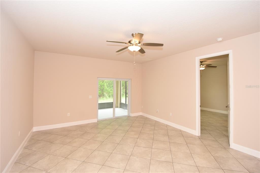 16 Serbian Bellflower Trail, Unit A Palm Coast, FL 32164 - Photo 18 of 41 an empty room with closet and a chandelier fan