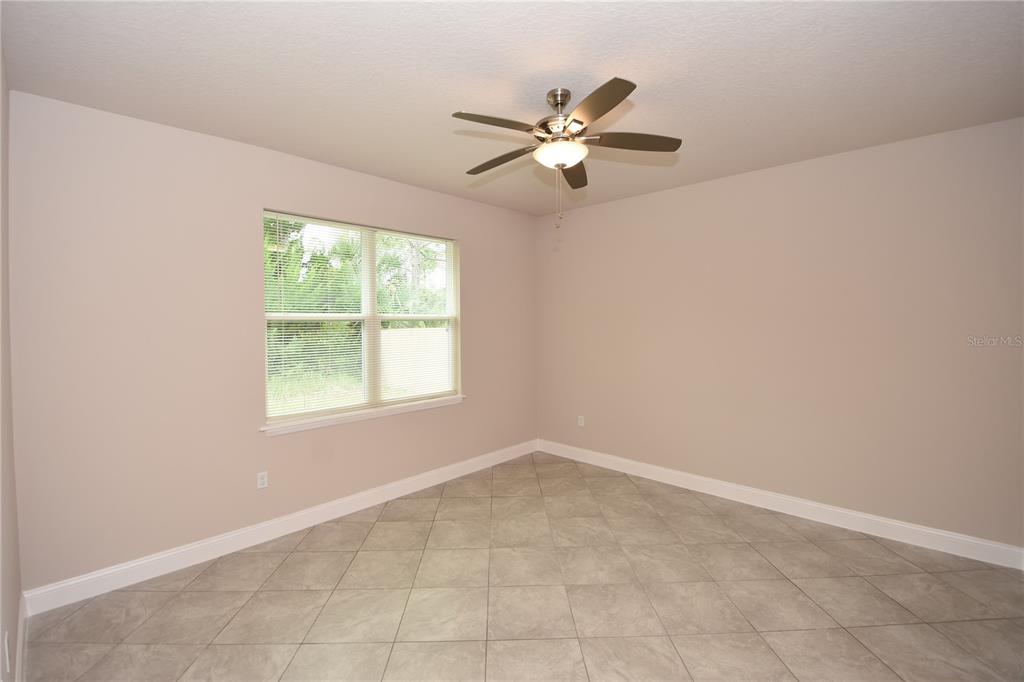 16 Serbian Bellflower Trail, Unit A Palm Coast, FL 32164 - Photo 19 of 41 an empty room with windows and fan
