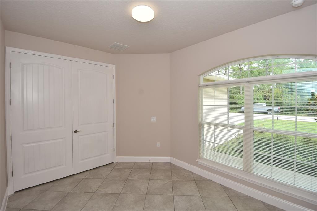 16 Serbian Bellflower Trail, Unit A Palm Coast, FL 32164 - Photo 28 of 41 an empty room with wooden floor and windows
