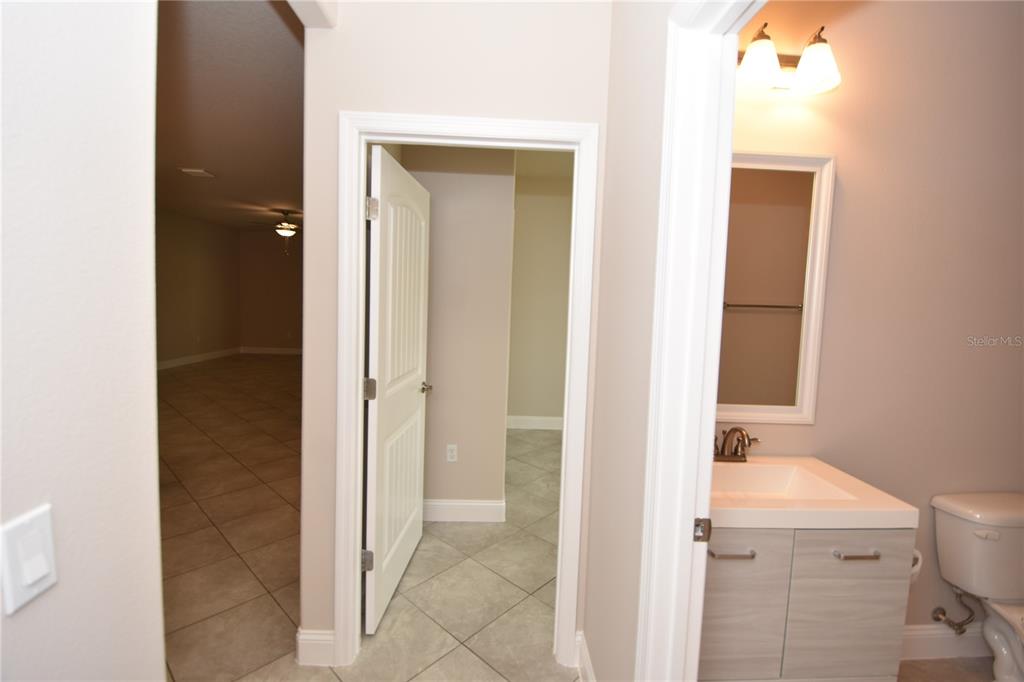 16 Serbian Bellflower Trail, Unit A Palm Coast, FL 32164 - Photo 32 of 41 a bathroom with a sink and a mirror