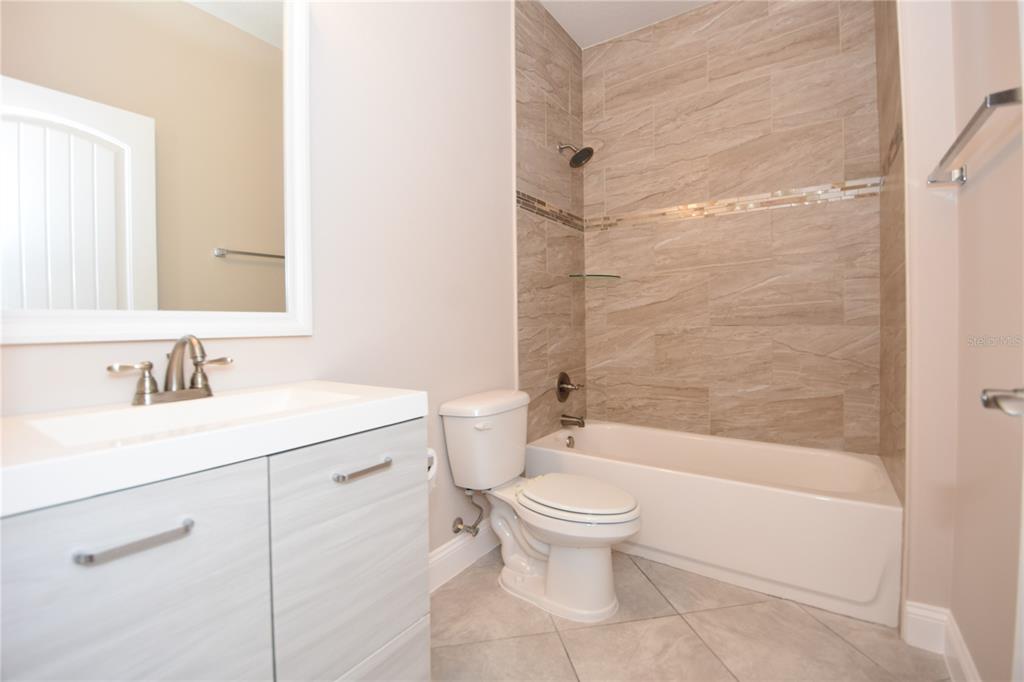 16 Serbian Bellflower Trail, Unit A Palm Coast, FL 32164 - Photo 38 of 41 a bathroom with a sink toilet and shower