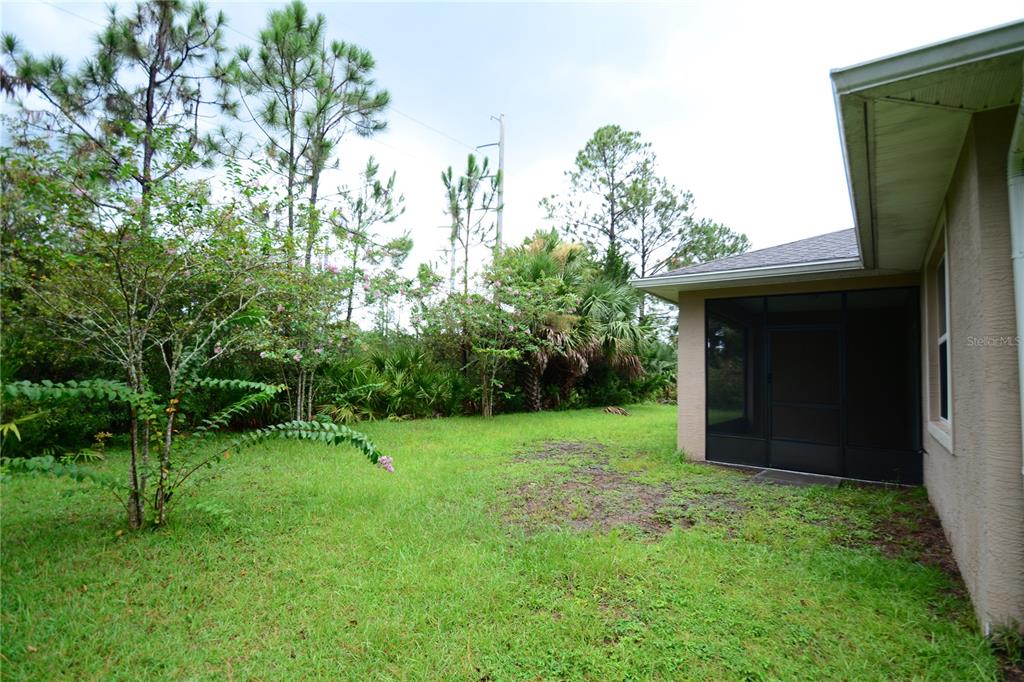 16 Serbian Bellflower Trail, Unit A Palm Coast, FL 32164 - Photo 40 of 41 a view of an outdoor space and a yard
