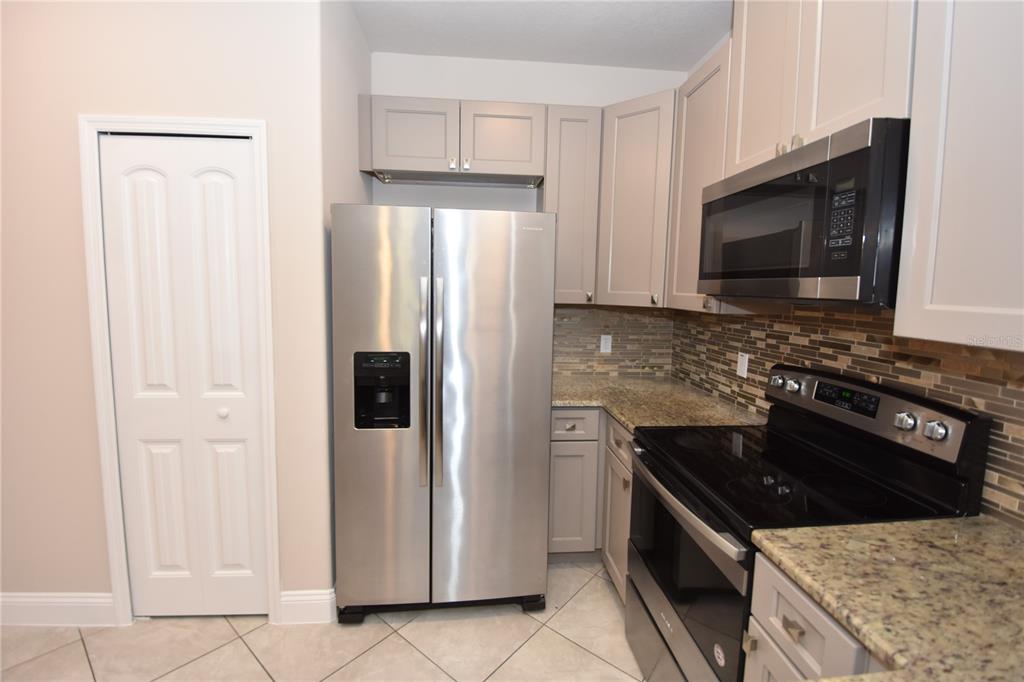 16 Serbian Bellflower Trail, Unit A Palm Coast, FL 32164 - Photo 8 of 41 a kitchen with granite countertop a sink stove and refrigerator