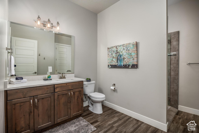 2600 Ocotillo Way, Unit 34 Santa Clara, UT 84765 - Photo 13 of 43 Full bathroom featuring vanity, dark wood finished floors, and a tile shower