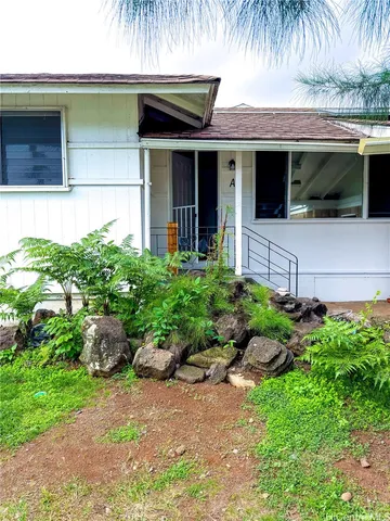 front view of a house with a garden