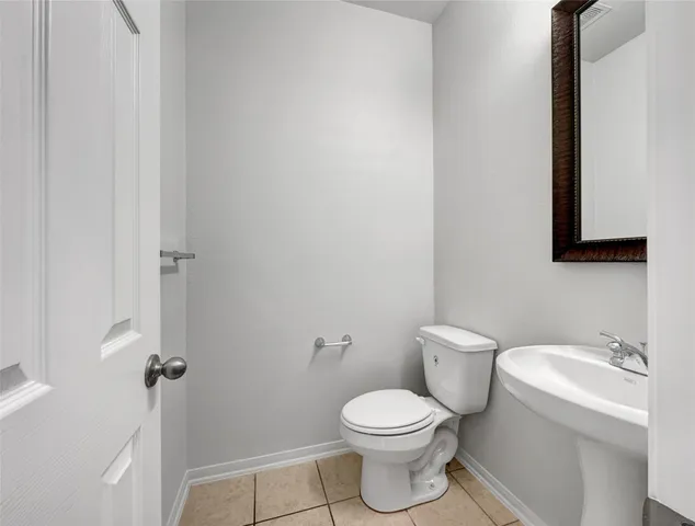 a white toilet sitting next to a bathroom sink