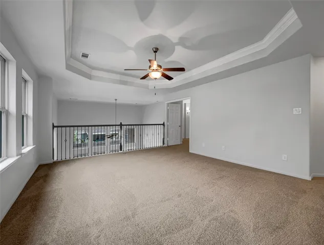 a view of a livingroom with a ceiling fan and window