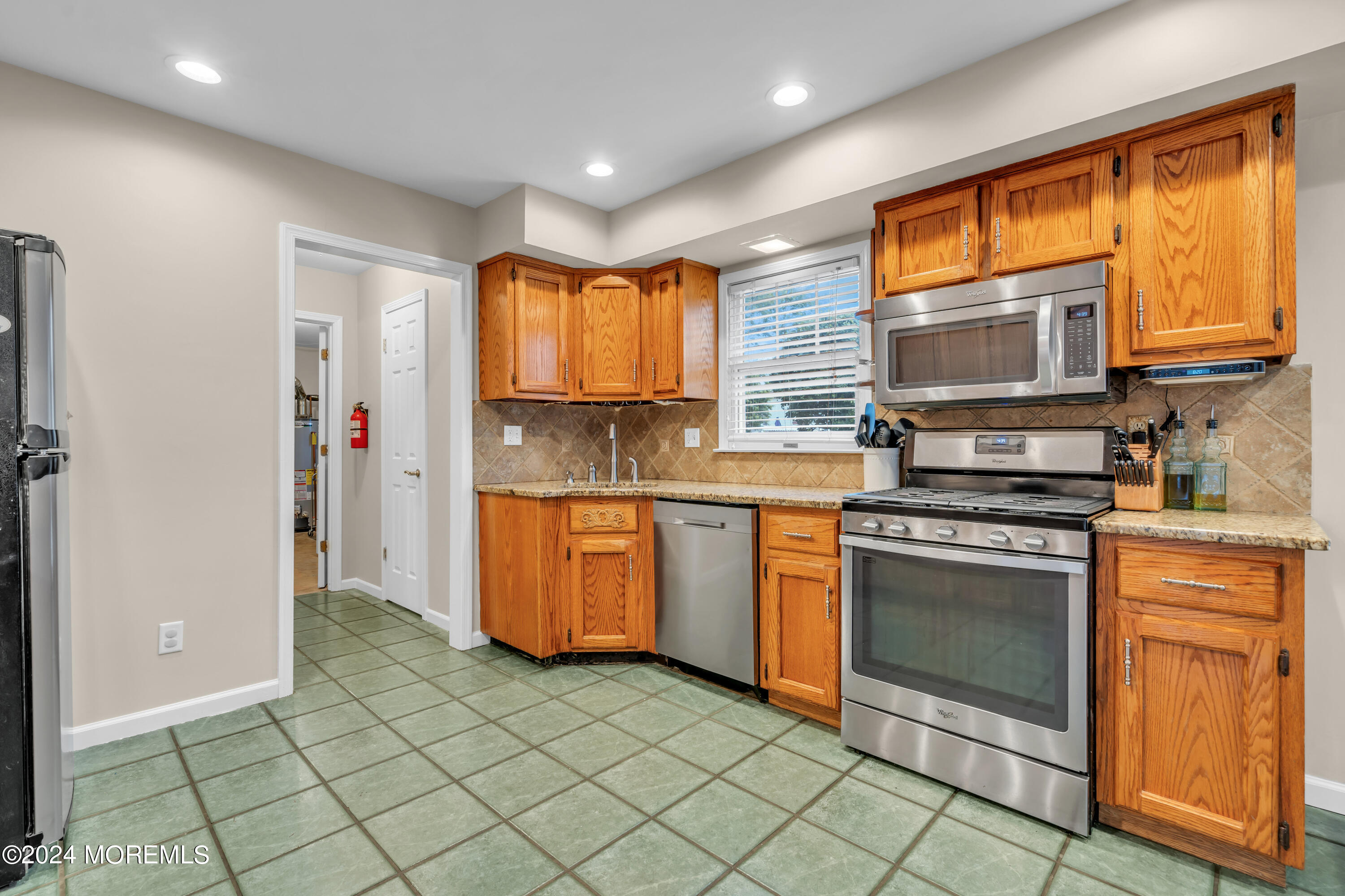 15 Spicy Pond Road Howell, NJ 07731 - Photo 20 of 74 a kitchen with stainless steel appliances granite countertop a stove a sink and a microwave