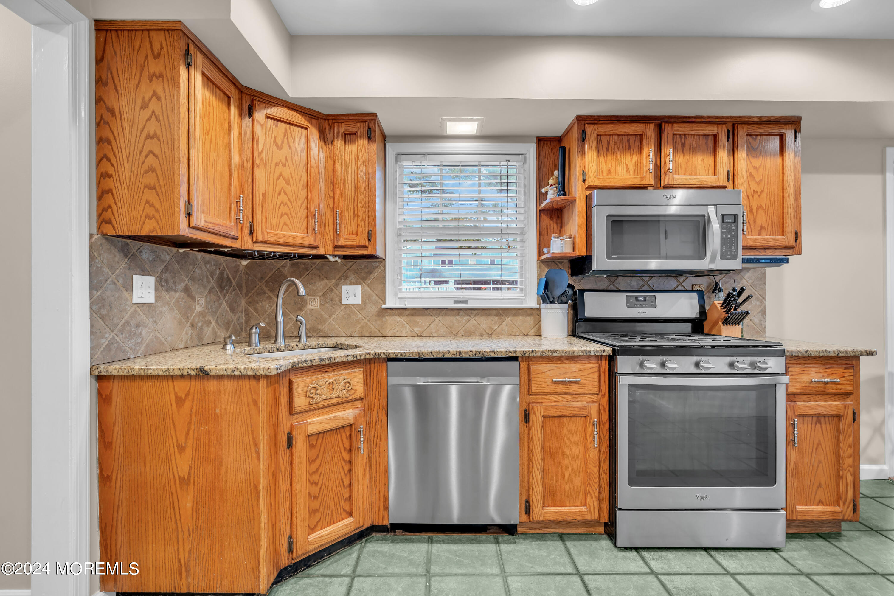 15 Spicy Pond Road Howell, NJ 07731 - Photo 21 of 74 a kitchen with stainless steel appliances granite countertop a stove a sink and a microwave