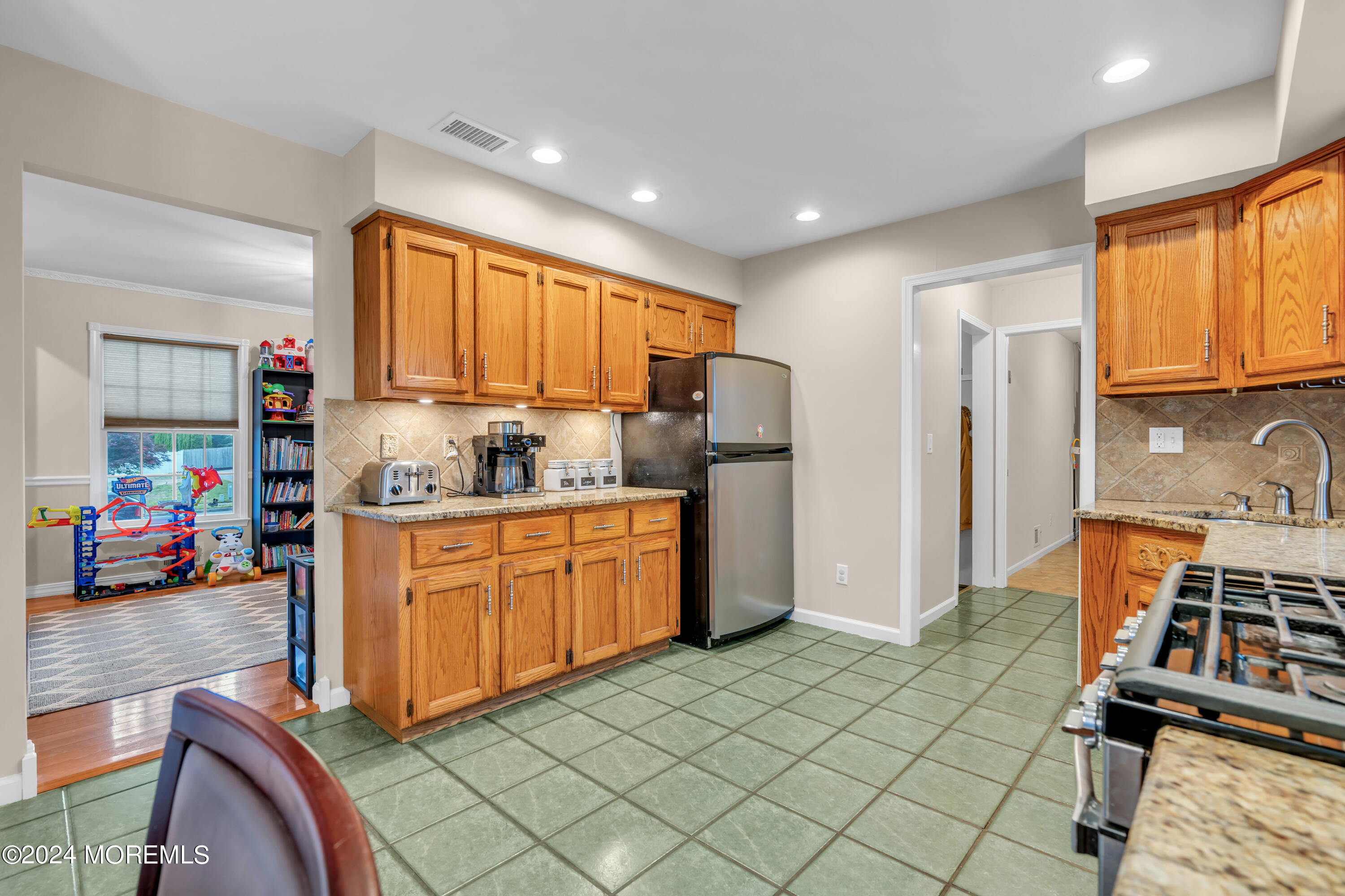 15 Spicy Pond Road Howell, NJ 07731 - Photo 22 of 74 a kitchen with stainless steel appliances granite countertop a refrigerator sink and wooden cabinets