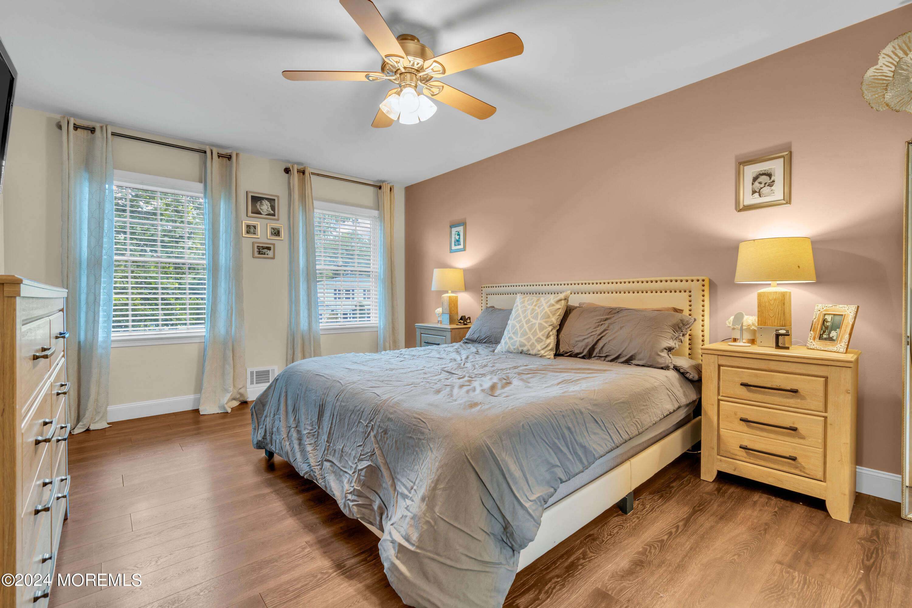 15 Spicy Pond Road Howell, NJ 07731 - Photo 36 of 74 a bedroom with a large bed and a chandelier