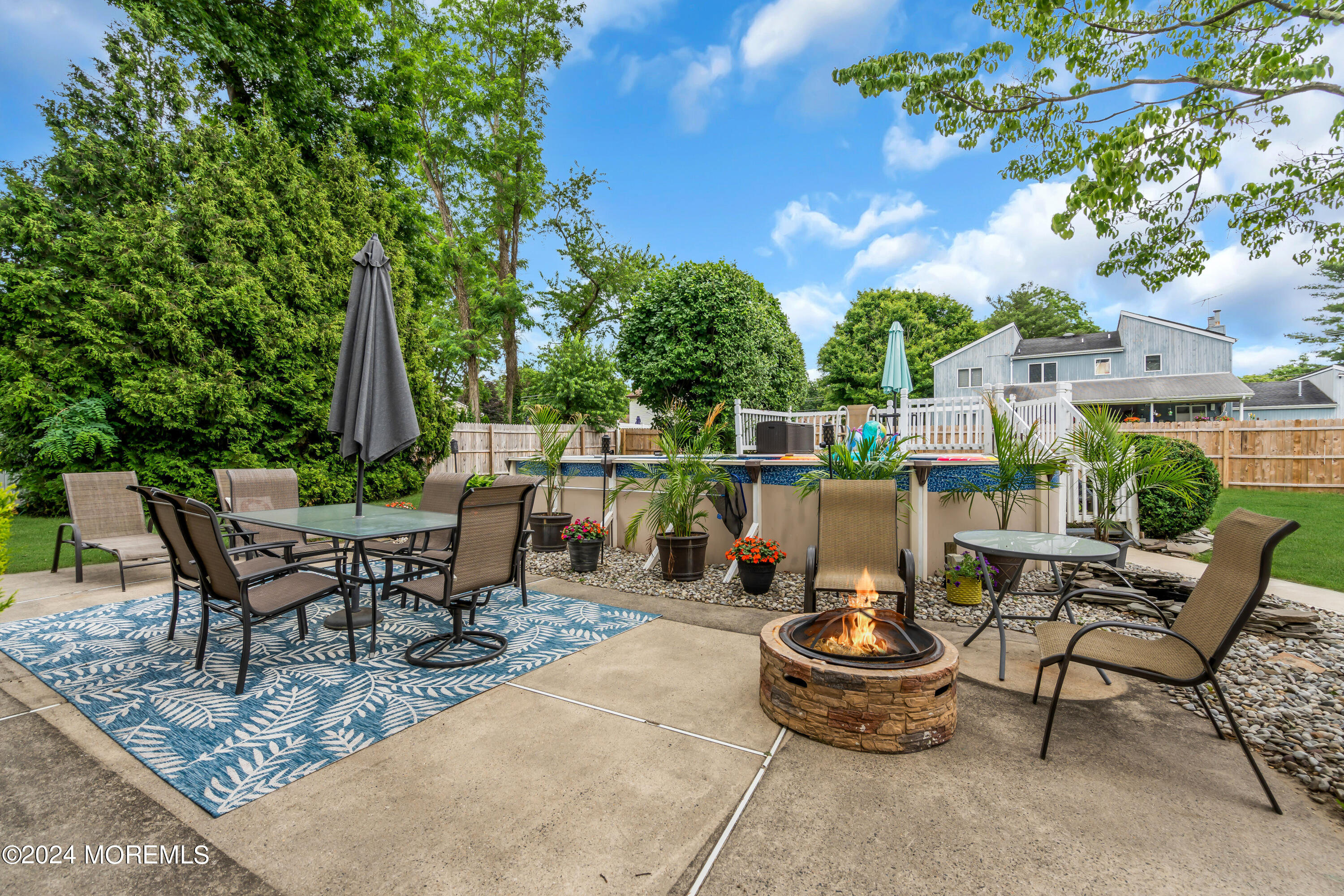15 Spicy Pond Road Howell, NJ 07731 - Photo 54 of 74 a view of a patio with table and chairs potted plants and large tree