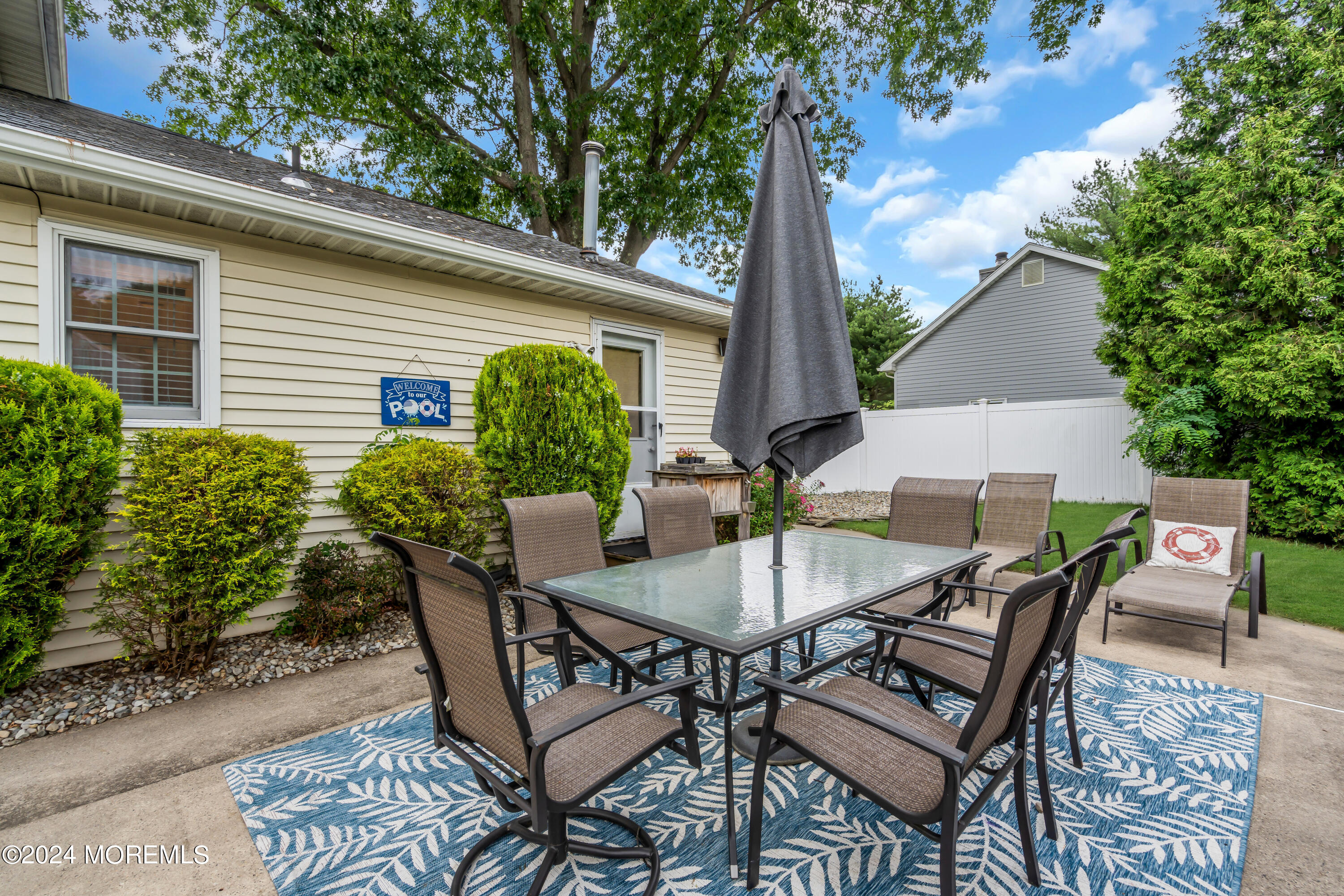 15 Spicy Pond Road Howell, NJ 07731 - Photo 58 of 74 a view of a patio with table and chairs and potted plants