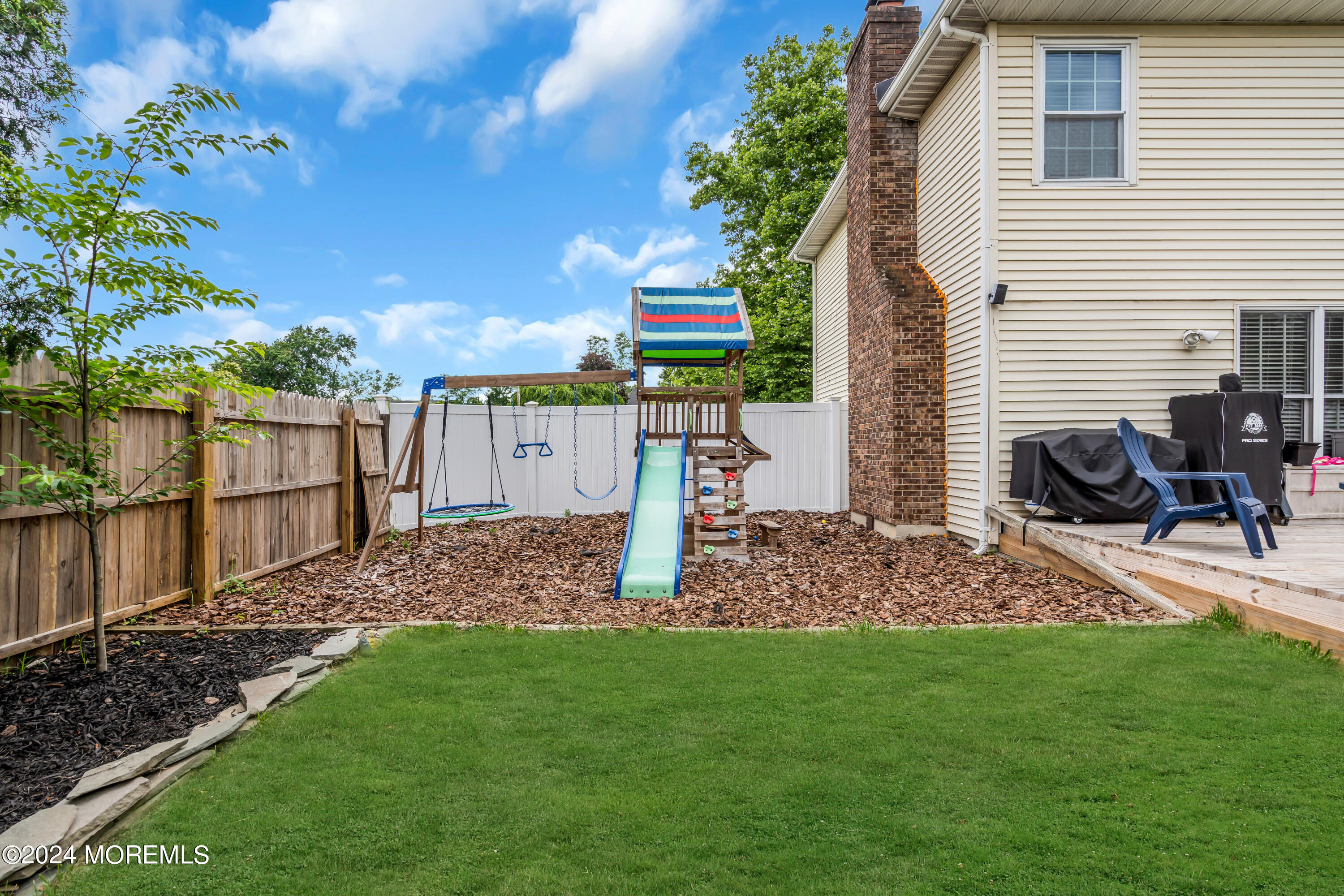 15 Spicy Pond Road Howell, NJ 07731 - Photo 62 of 74 a view of a patio with a table and chairs under an umbrella