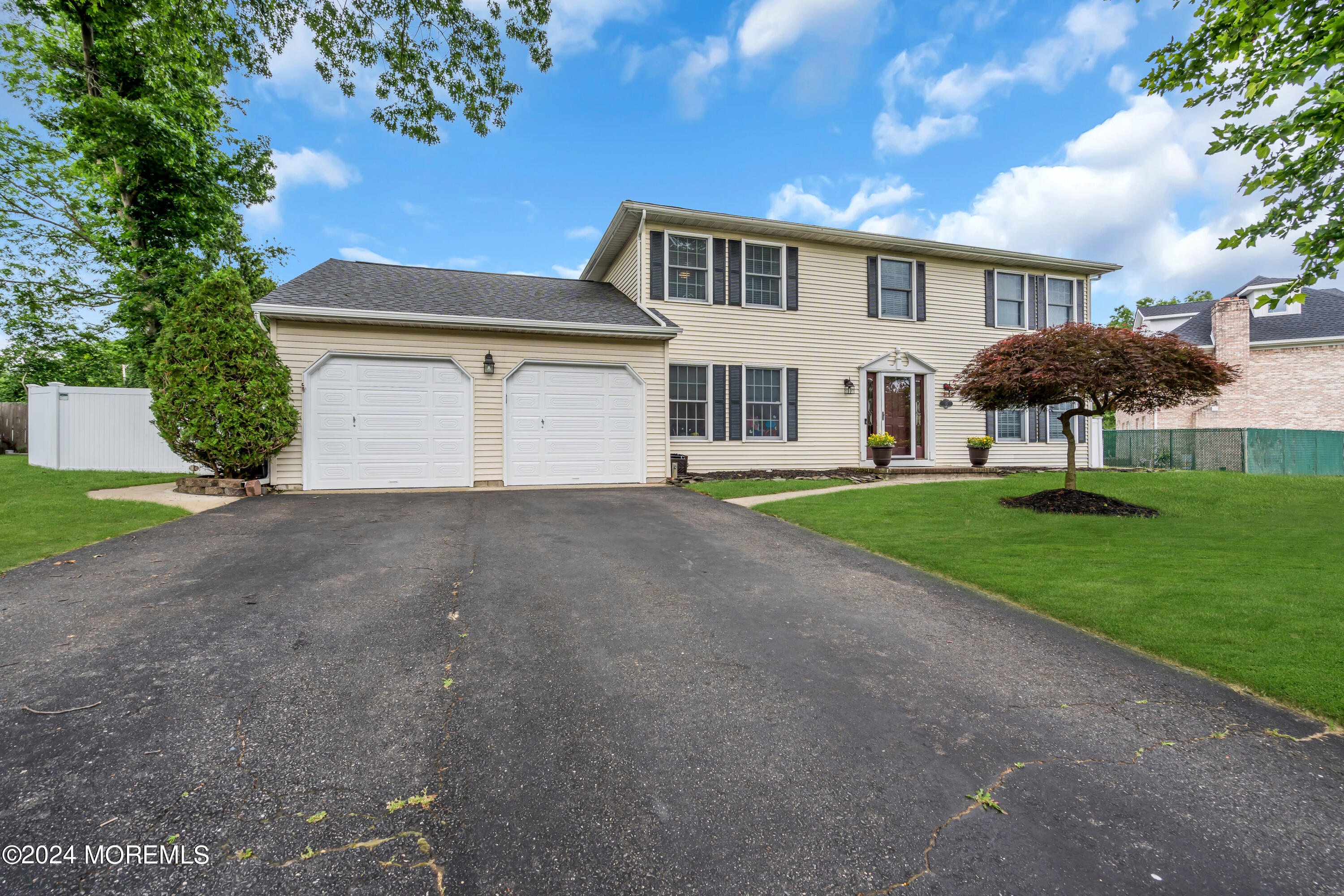 15 Spicy Pond Road Howell, NJ 07731 - Photo 67 of 74 a front view of a house with garden and trees