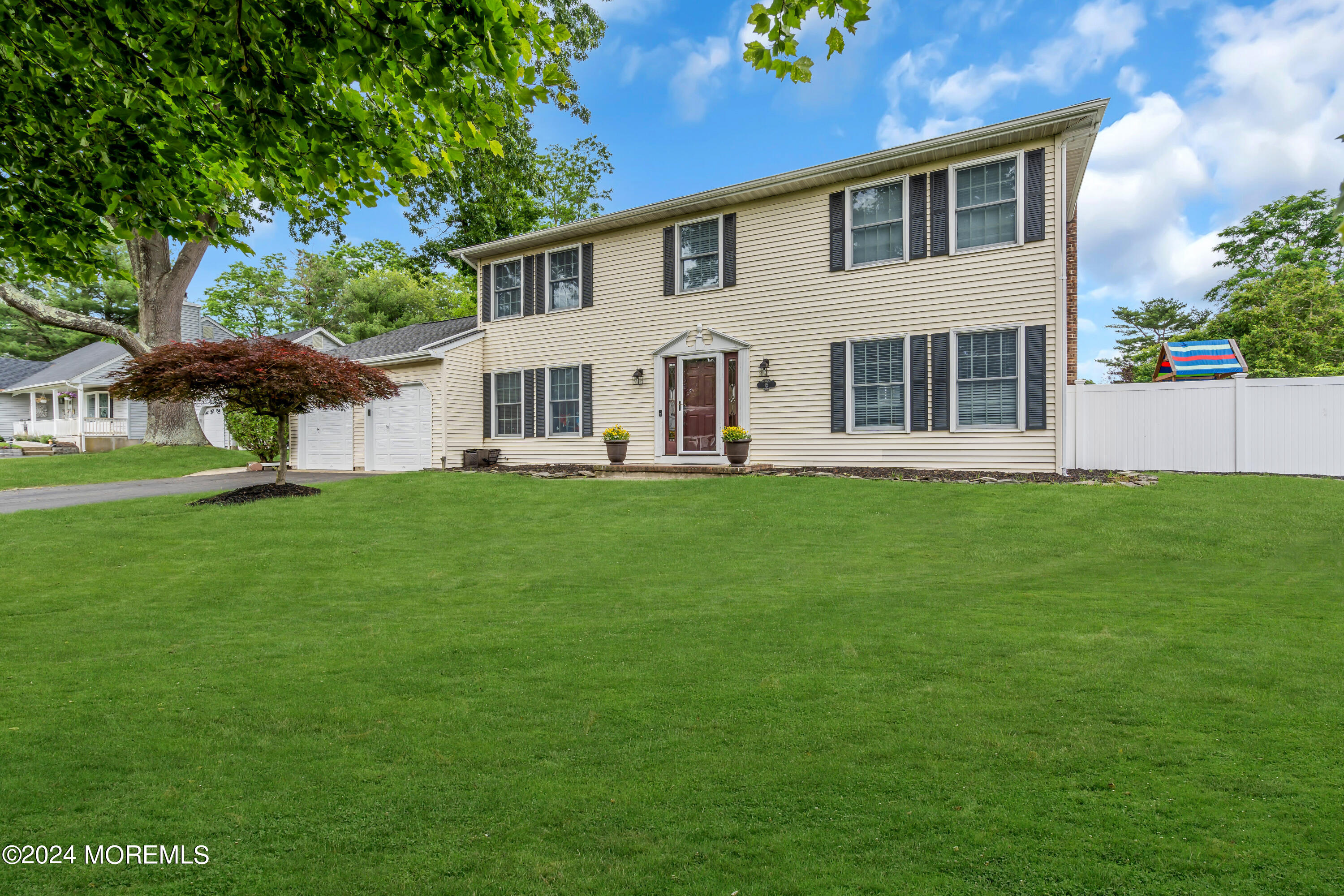 15 Spicy Pond Road Howell, NJ 07731 - Photo 70 of 74 a front view of a house with a garden and trees