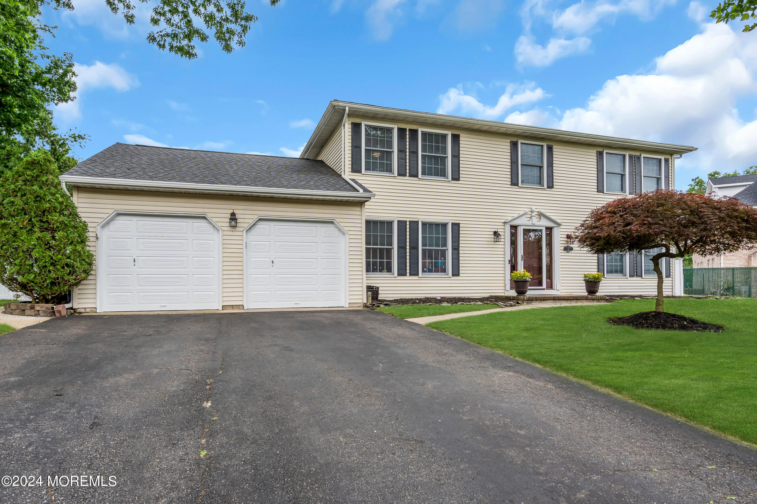 15 Spicy Pond Road Howell, NJ 07731 - Photo 73 of 74 a front view of a house with a yard and garage