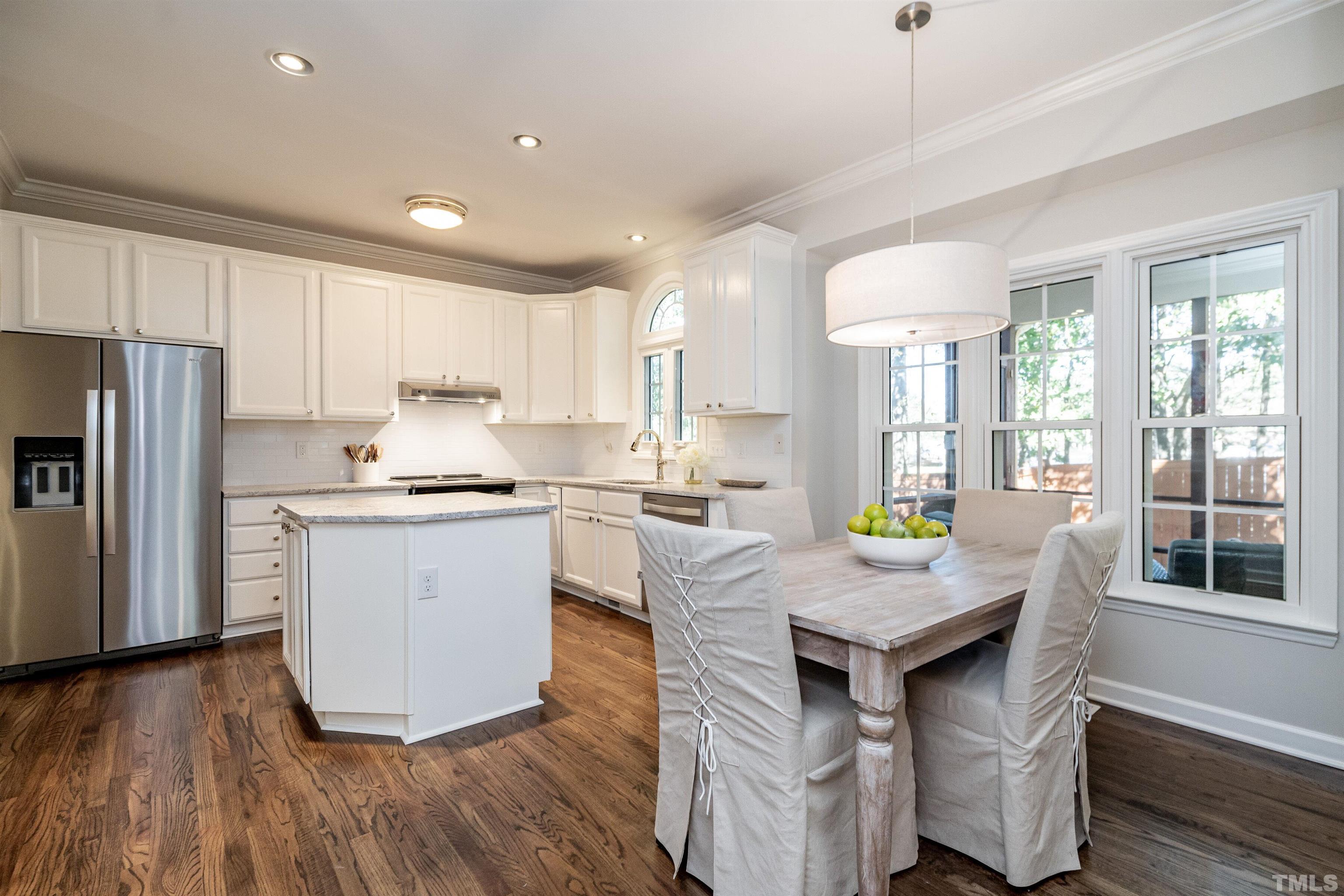 2420 Havershire Drive Raleigh, NC 27613 - Photo 8 of 25 a kitchen with a refrigerator a sink dishwasher with a dining table and chairs