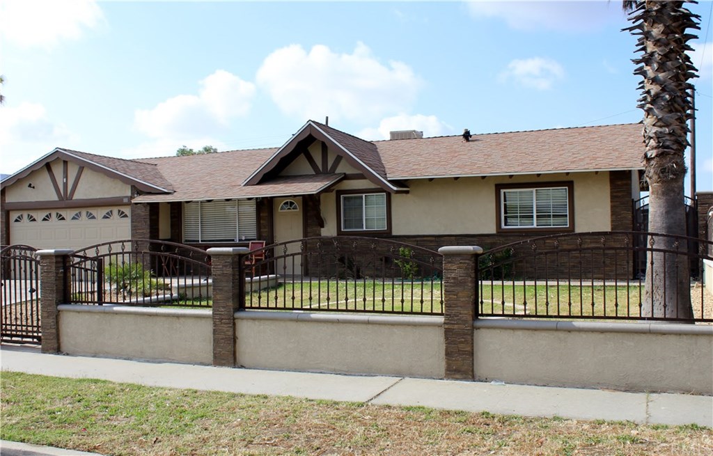 881 Lorraine Place Rialto, CA 92376 - Photo 1 of 1 a front view of a house with a garden and plants
