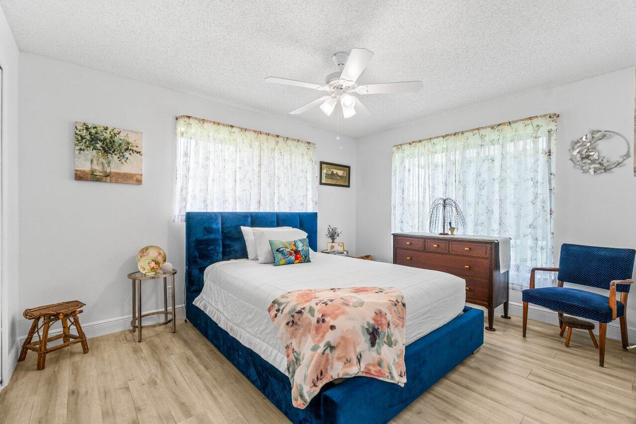4260 Mango Tree Court, Unit B Boynton Beach, FL 33436 - Photo 16 of 35 a bedroom with a bed a table and chair