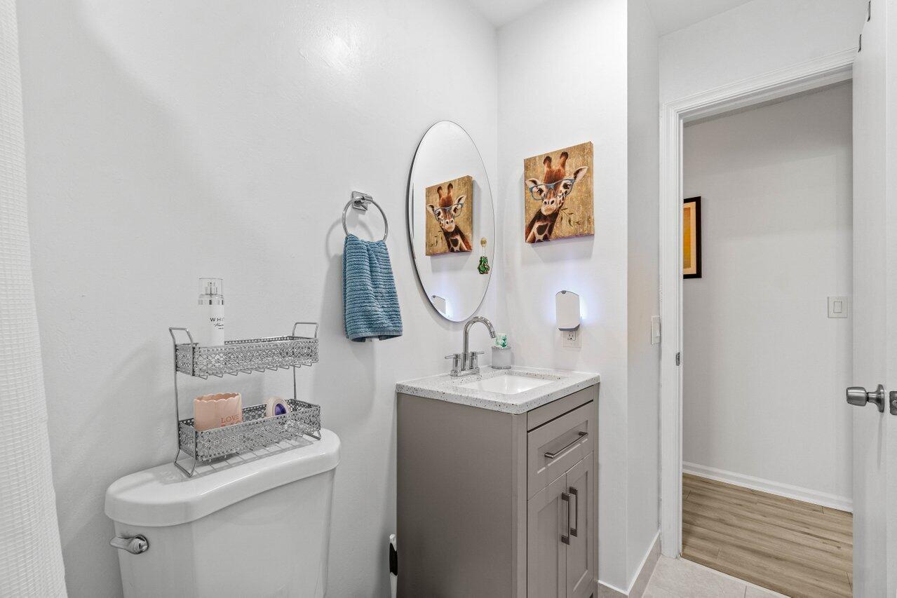 4260 Mango Tree Court, Unit B Boynton Beach, FL 33436 - Photo 18 of 35 a bathroom with a sink vanity and mirror