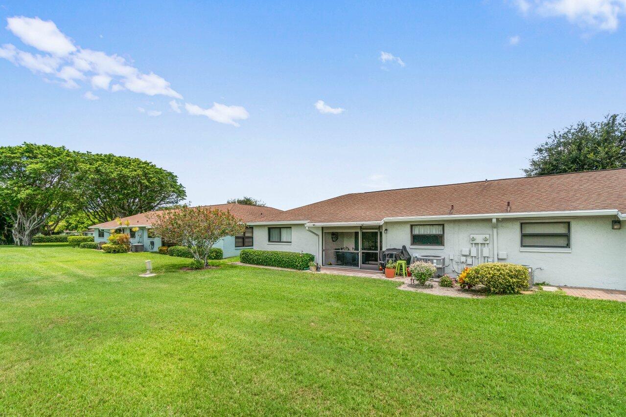 4260 Mango Tree Court, Unit B Boynton Beach, FL 33436 - Photo 23 of 35 a view of a house with a backyard porch and sitting area