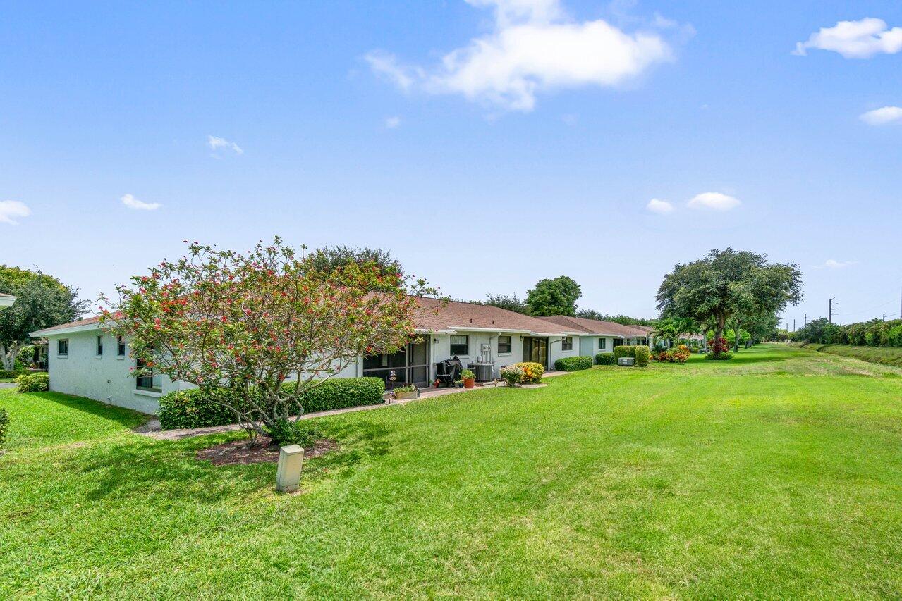 4260 Mango Tree Court, Unit B Boynton Beach, FL 33436 - Photo 24 of 35 a view of a house with a big yard