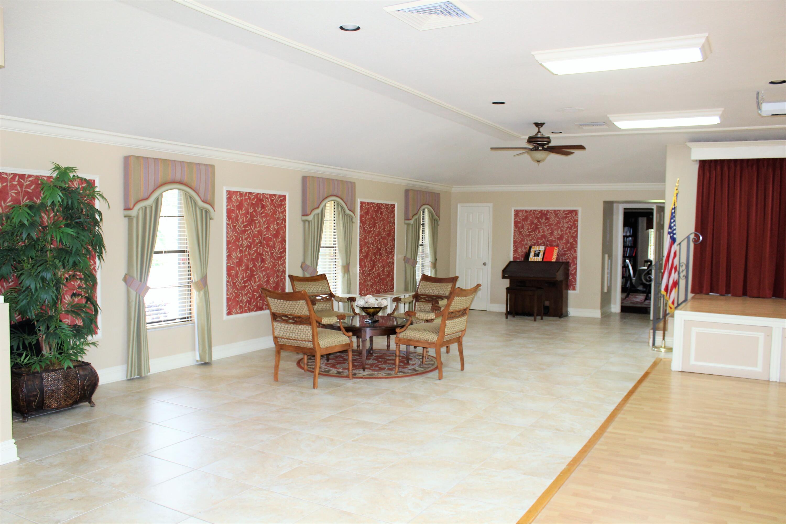 4260 Mango Tree Court, Unit B Boynton Beach, FL 33436 - Photo 28 of 35 a living room with furniture and a fireplace