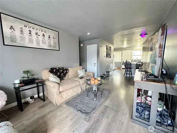 a living room with furniture and wooden floor
