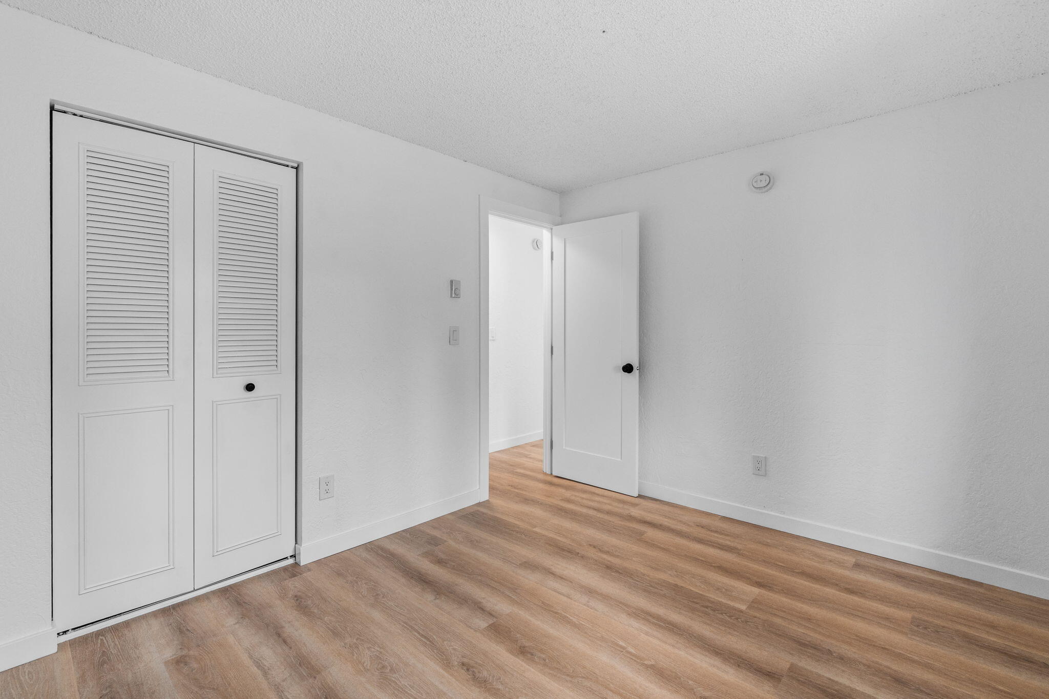 1700 Northeast Wells Acres Road, Unit 25 Bend, OR 97701 - Photo 18 of 25 a view of empty room with wooden floor