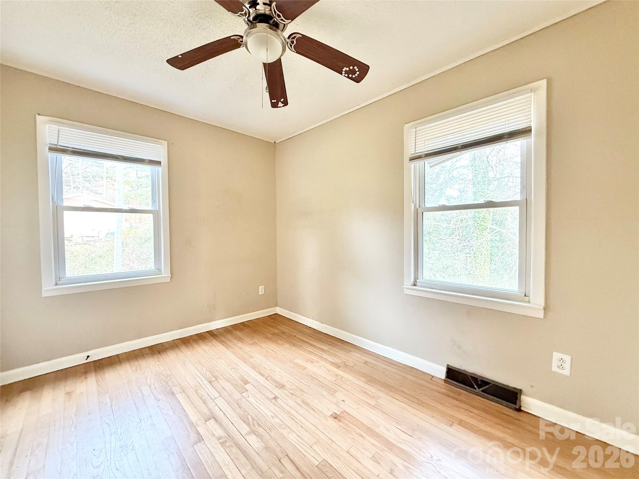 406 North Rutherford Street Wadesboro, NC 28170 - Photo 8 of 9 a view of an empty room with wooden floor and a window