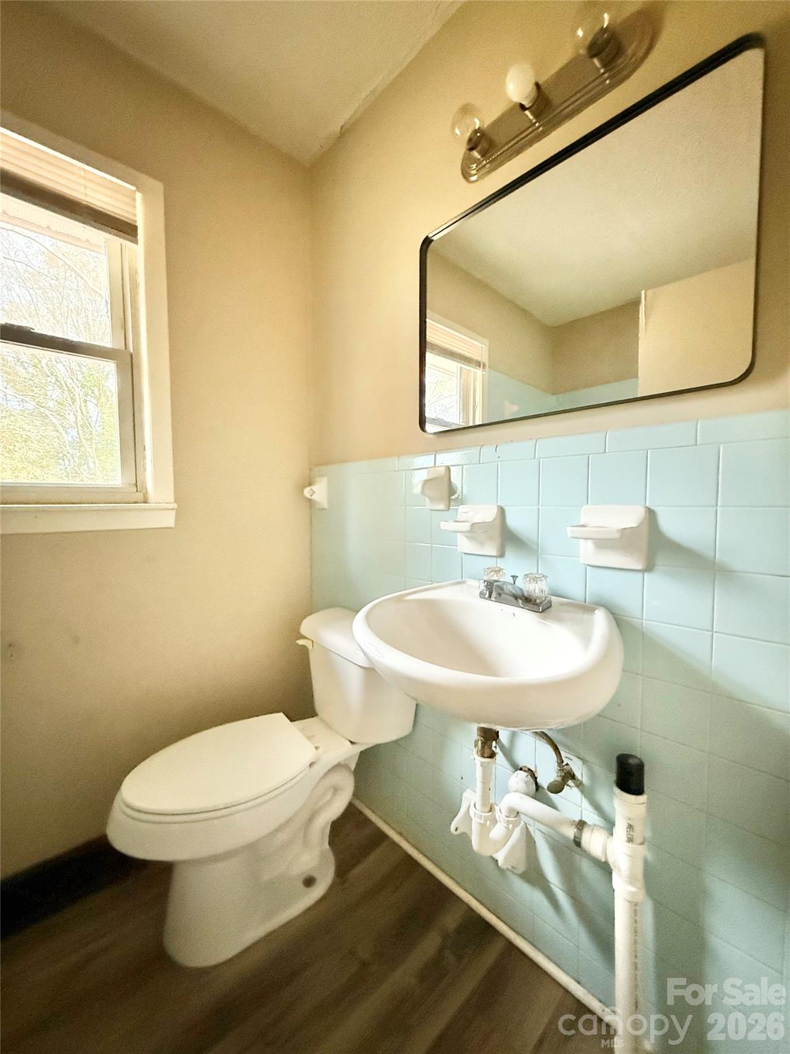 406 North Rutherford Street Wadesboro, NC 28170 - Photo 9 of 9 a bathroom with a sink a toilet and a mirror