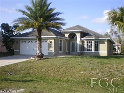 8349 Bahamas Road Fort Myers, FL 33967 - Photo 1 of 10 a front view of a house with garden